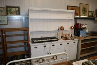 A white painted kitchen dresser fitted six drawers