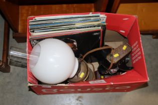 A box containing LPs, oil lamp with milk glass sha