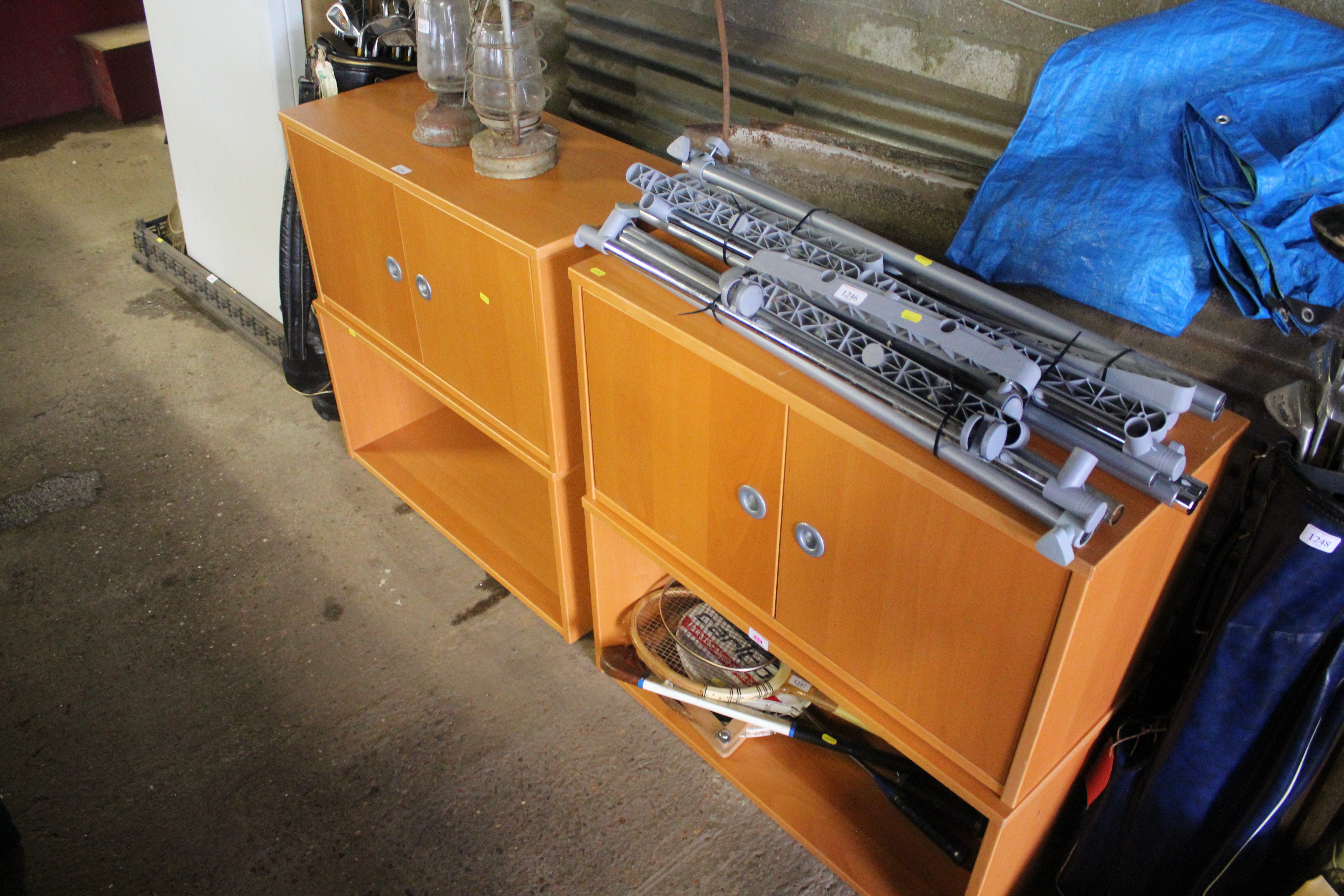 A pair of modern storage cupboards raised on shelf