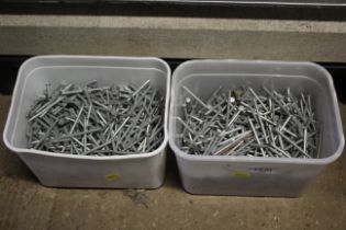 Two plastic tubs of various galvanized nails