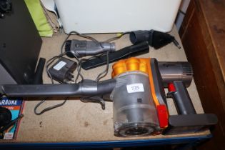 A Dyson hand held vacuum cleaner and various attac