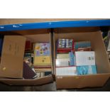 Two boxes containing various books