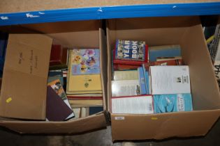 Two boxes containing various books