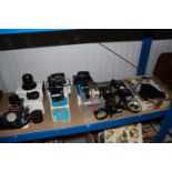 A quantity of various camera lenses and flash unit
