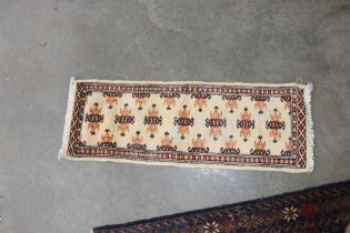 An approx. 3' x 1' Bokhara rug