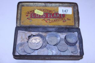 A Gold Flake advertising tin and contents of coina
