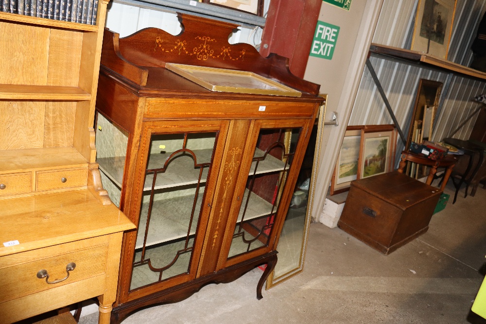 An Edwardian display cabinet with inlaid decoratio