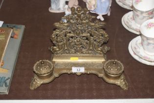 A brass desk stand with two inkwells