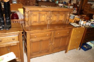 An Ercol court cupboard fitted two drawers