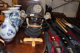 An Kabuto reproduction Samurai helmet on stand