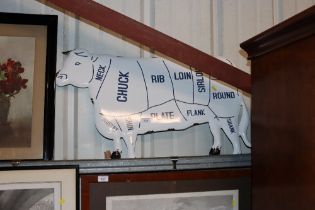 An enamel cow sign