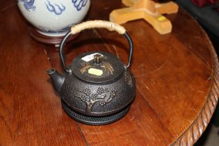 A Japanese tea pot on stand