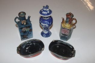 A pair of Oriental dishes decorated with figures;