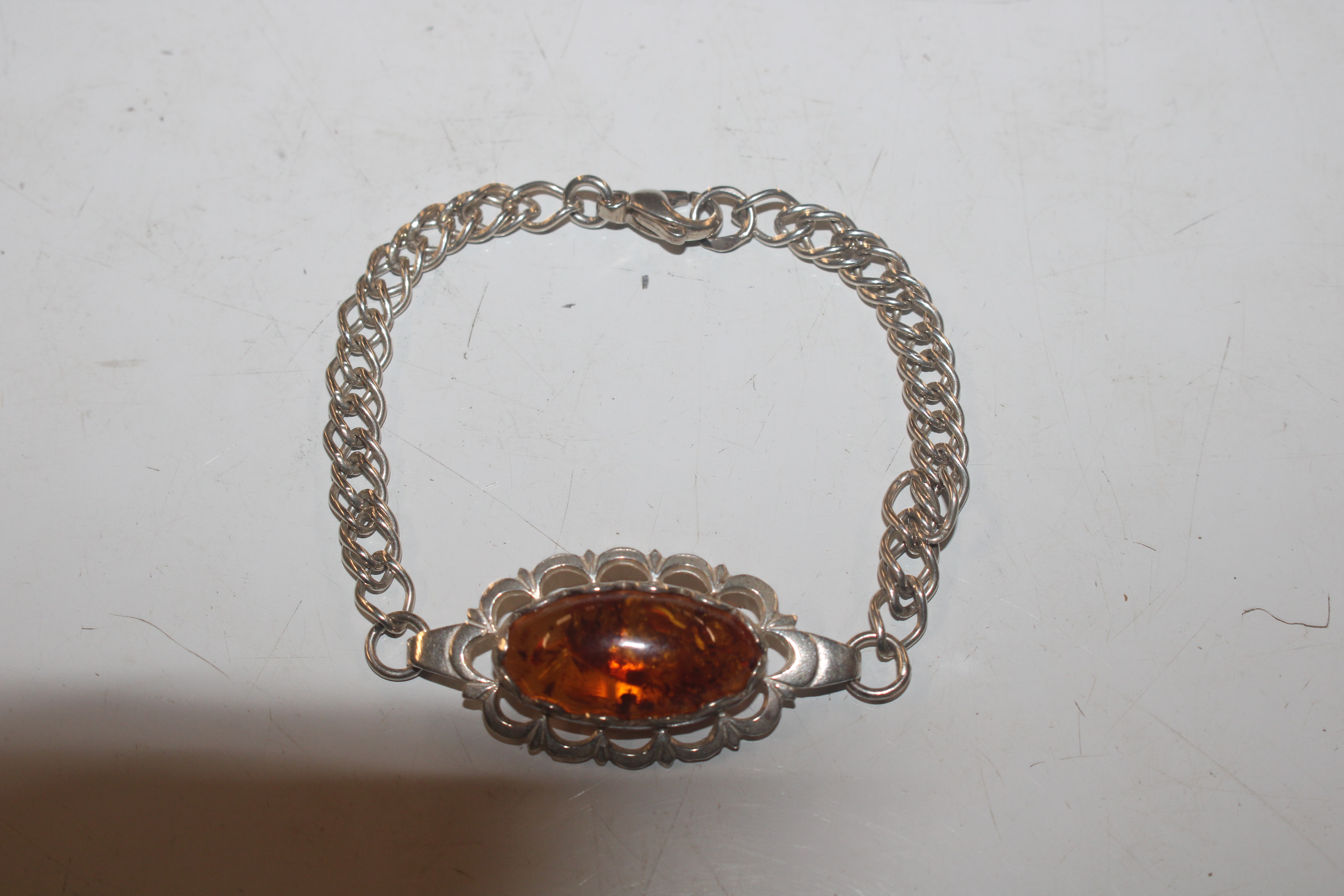 A vintage Sterling silver and amber bracelet, appr
