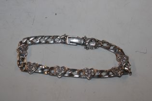 A silver and white stone bracelet decorated with h