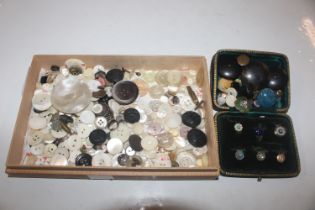 A box containing mother of pearl and other buttons