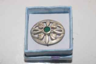 A Sterling silver Kit Heath brooch with green ston