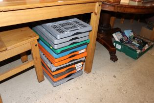 Twelve folding plastic storage crates