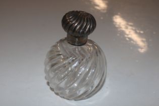 A glass and silver topped scent bottle