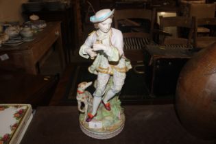 A porcelain figure with attendant dog, initialled