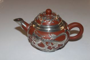 A Chinese redware teapot with applied white metal