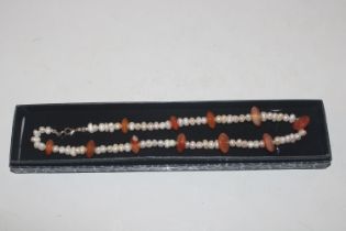 A freshwater pearl and amber necklace