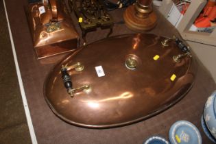 A large copper and brass warming pan