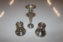 Two silver candlesticks with weighted bases; and a