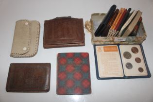 A collection of coins, purses, booklets etc.