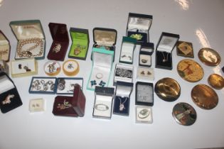 A box of various costume jewellery and compacts