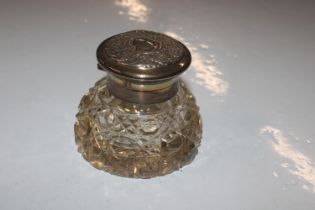 A cut glass and silver topped inkwell