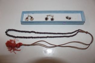 A string of graduated garnets and three pairs of S