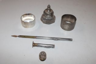 A white metal coil; a white metal handled seal; on