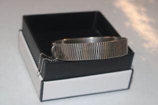 A 1975 London silver bark effect bangle