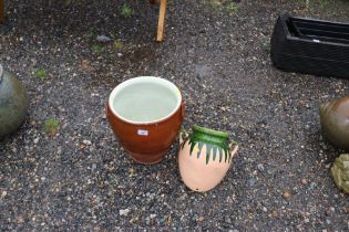 A glazed earthenware crock and a small garden pot