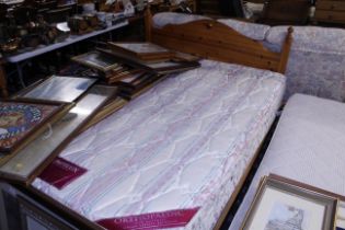 A double bed with pine headboard