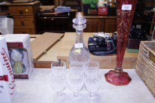 A Waterford decanter and six glasses, one glass wi