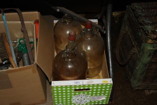 Three glass demijohns