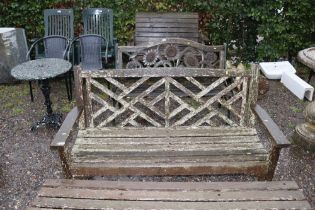 A wooden garden bench with slatted seat and back