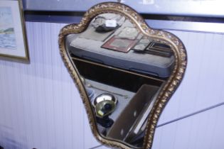 A decorative gilt framed wall mirror