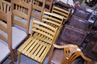 A set of three slat seated dining chairs