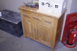 A modern lightwood dresser base