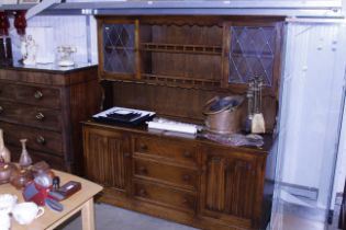 An oak dresser with linen fold panel doors