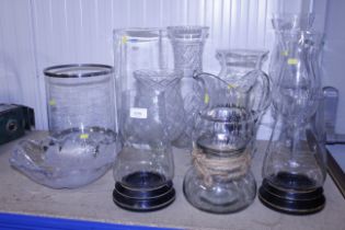 A collection of various glass vases, candle holder