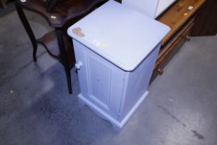 A blue painted bedside cupboard