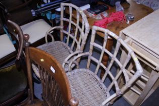 A pair of bamboo and wicker elbow chairs