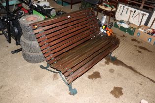 A metal and wooden slatted garden bench