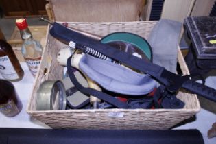 A box of military hats and other military items to include sword, shell case, horn etc.