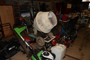 A cement mixer with Honda petrol engine on stand