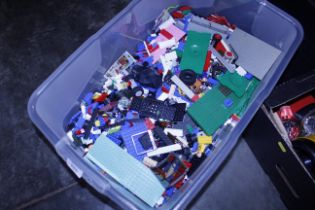 A tub of Lego including some figures
